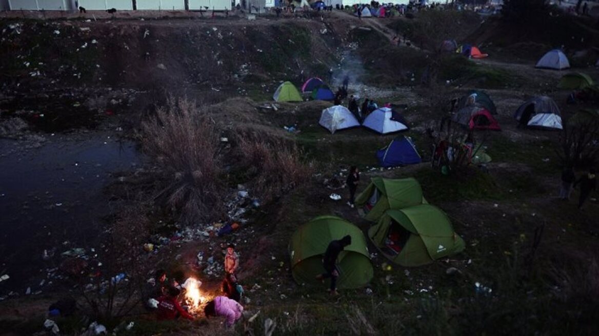 Desperate refugees and immigrants waiting in cold and muddy Idomeni