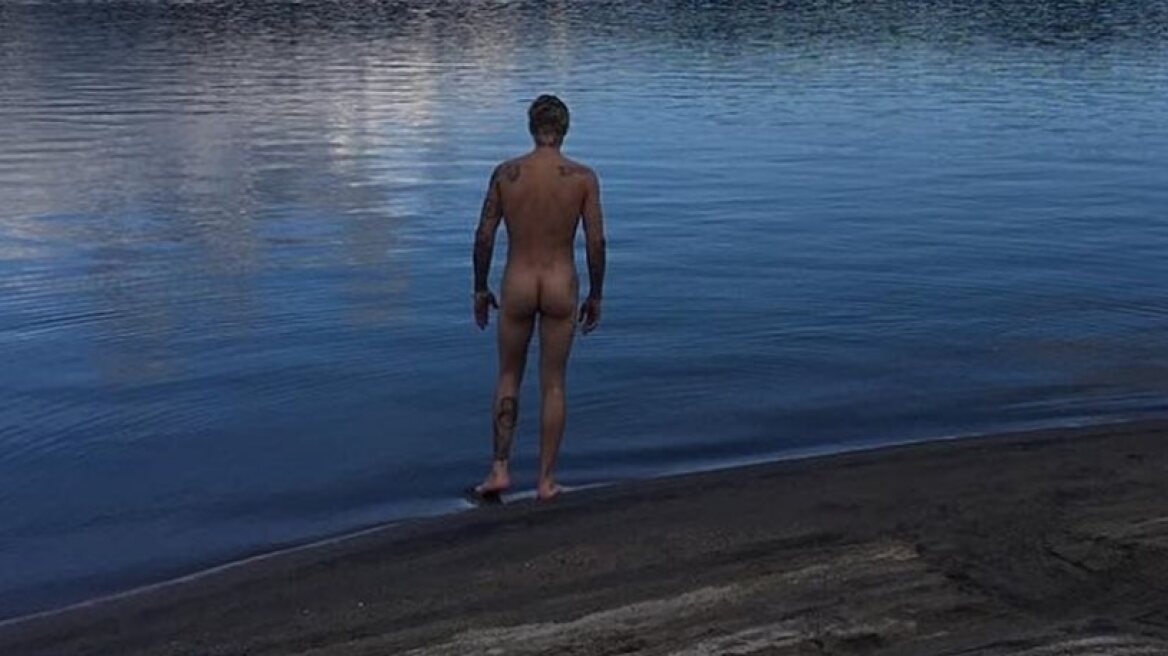 Justin Bieber poses naked during a camping trip