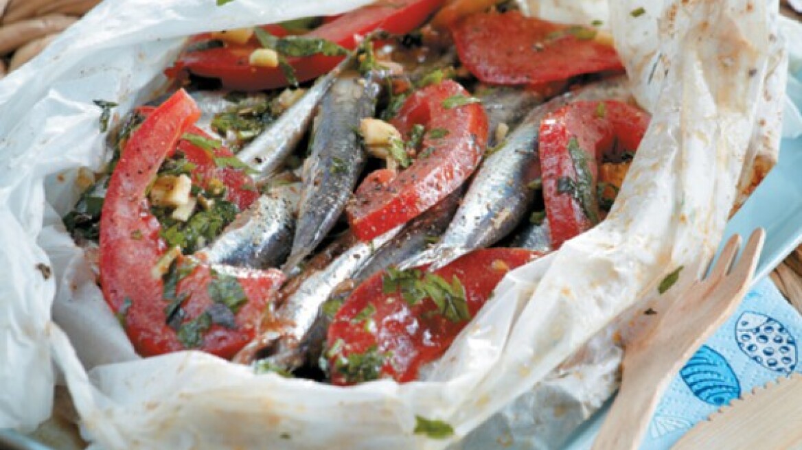 Parchment baked fresh anchovies with tomato and herbs
