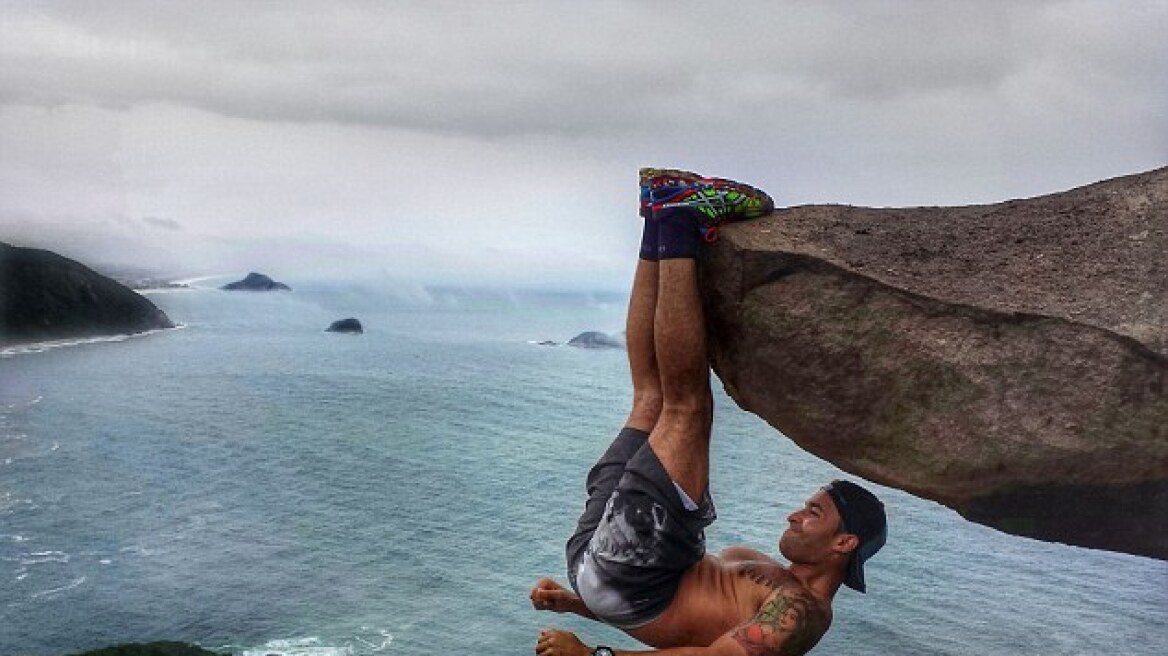 Fitness fanatic works out by dangling 1,000 feet above Brazilian beach (pics)