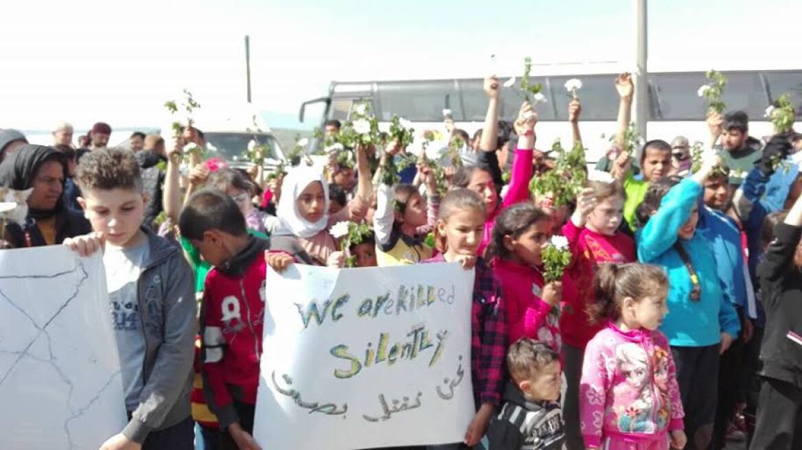 Διαμαρτυρία μικρών προσφύγων με λευκά λουλούδια στο φράχτη της Ειδομένης 