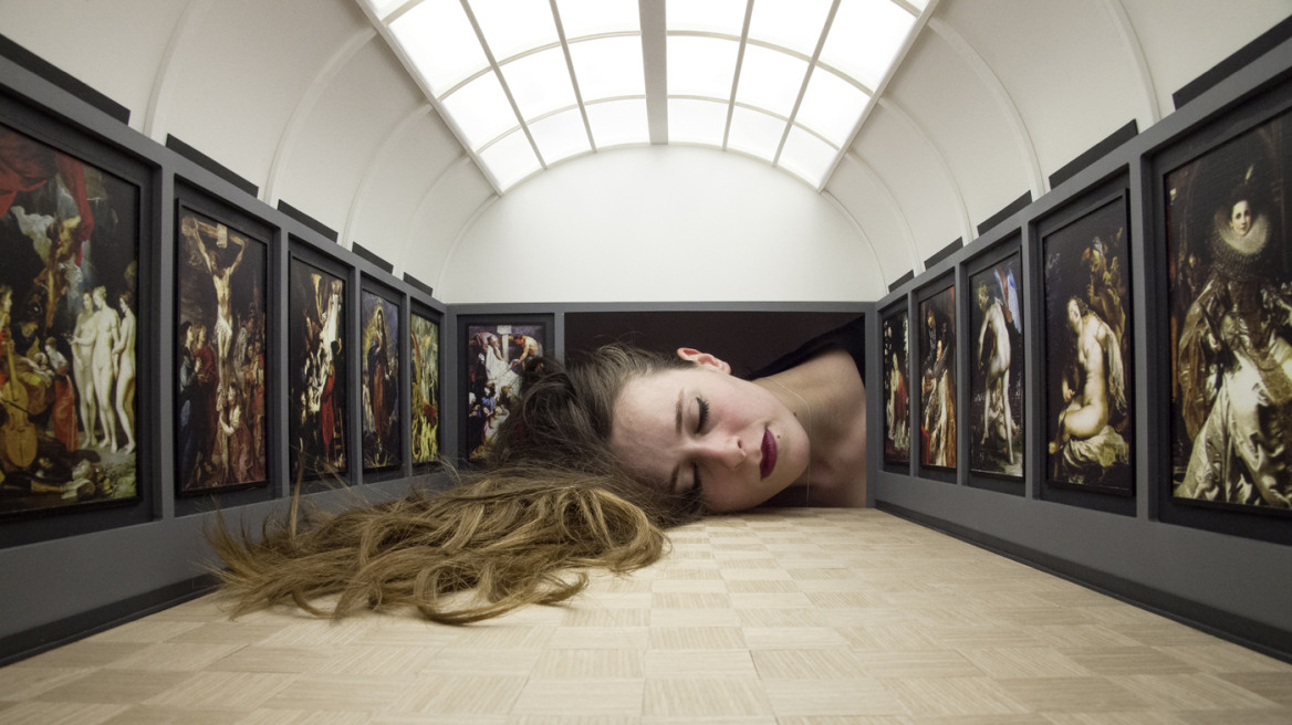 Images of big heads inside famous galleries