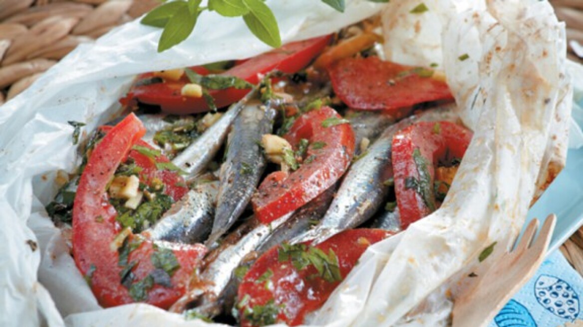 Parchment baked fresh anchovies with tomato and herbs