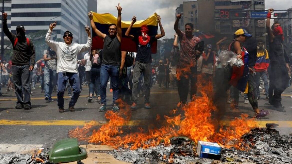 Venezuela’s Maduro jeered by crowd as unrest grows