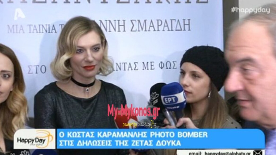 Ex-PM Karamanlis “photo-bombs” Zeta Douka TV interview! (video)