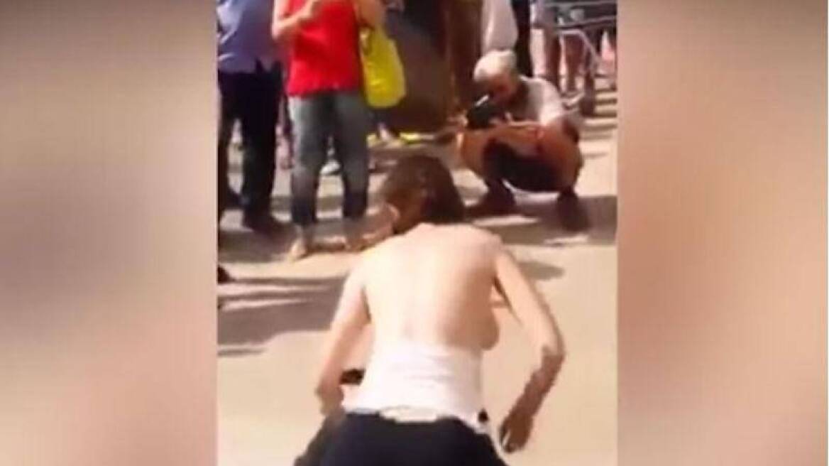  Woman in Brazil publicly rubs her bare breasts on a man’s face in bizarre anti-sexual harassment display! (RACY VIDEO)