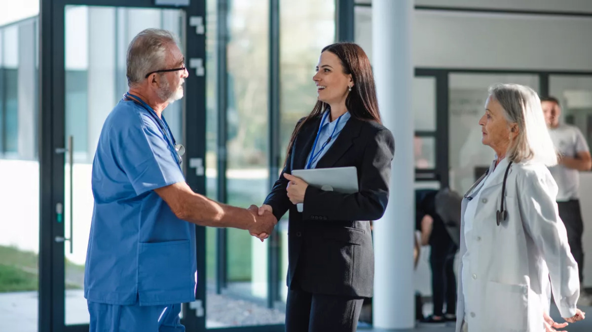 manager-with-doctors-in-hospital_shutterstock_2277711921