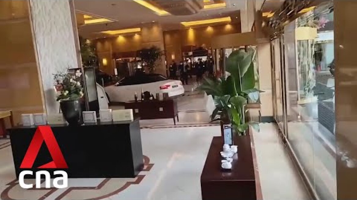 Man crashes car into hotel lobby in China