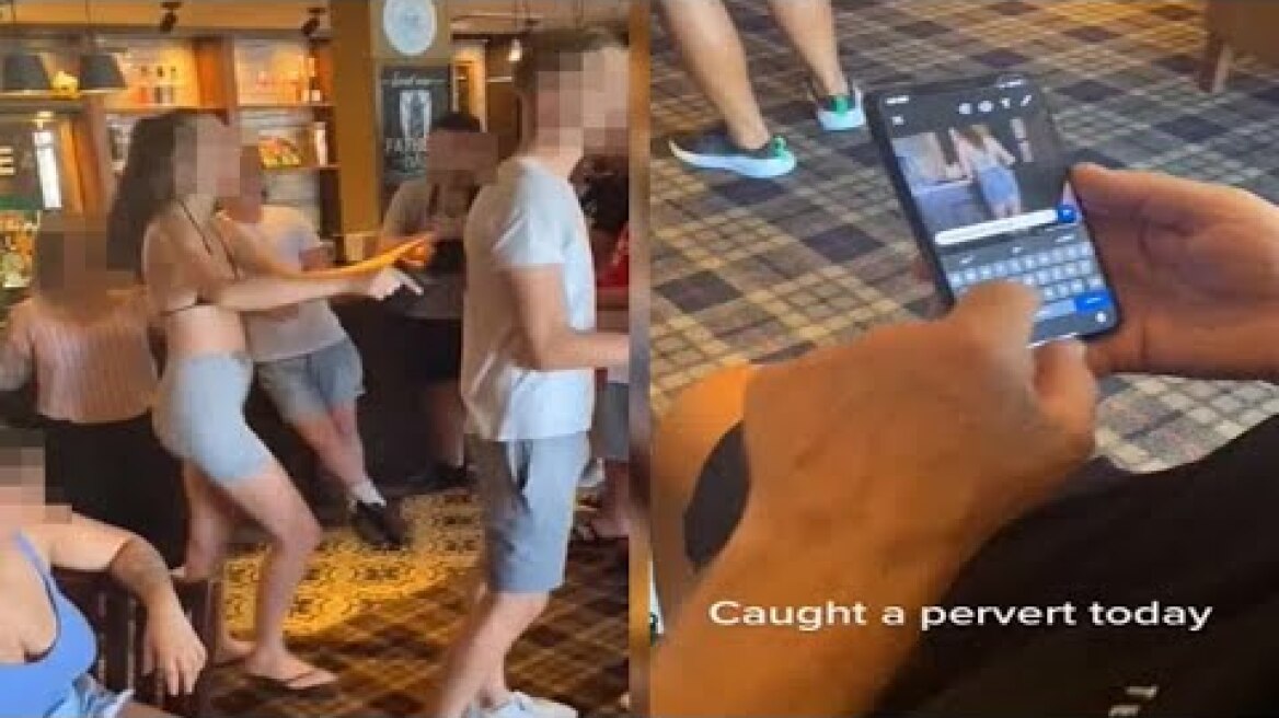 Moment pubgoer is caught looking at photo of woman's bum before being confronted