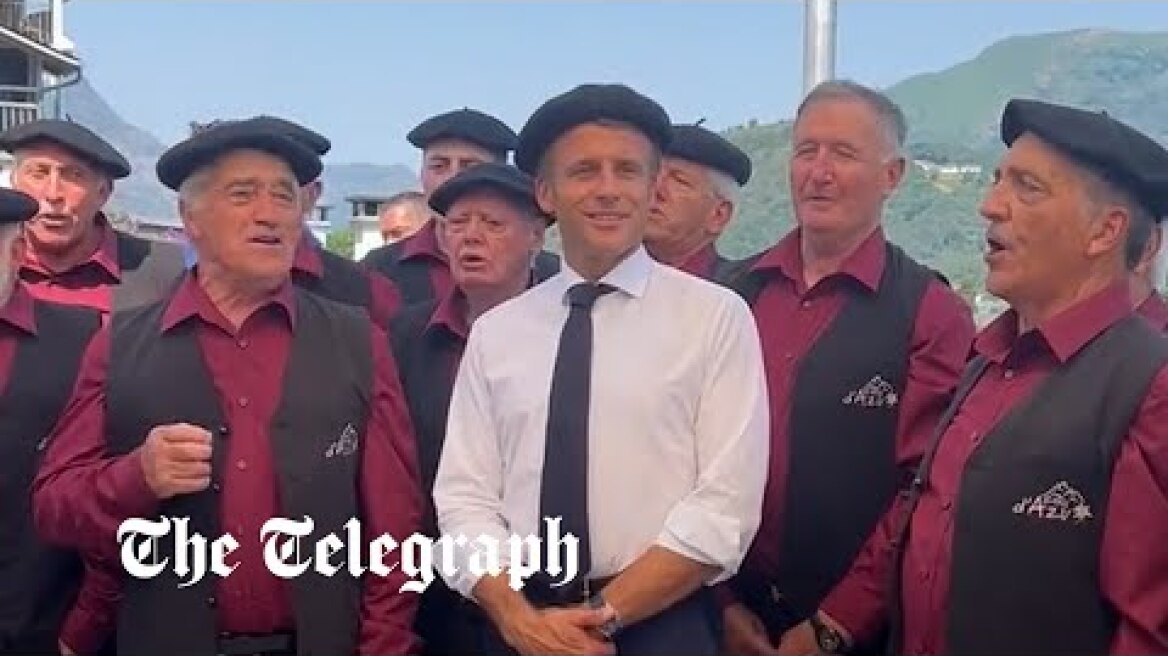 Emmanuel Macron dons a beret as he sings with Pyrenean shepherds