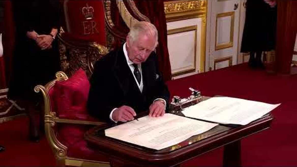 King Charles prompts aide to take pen away