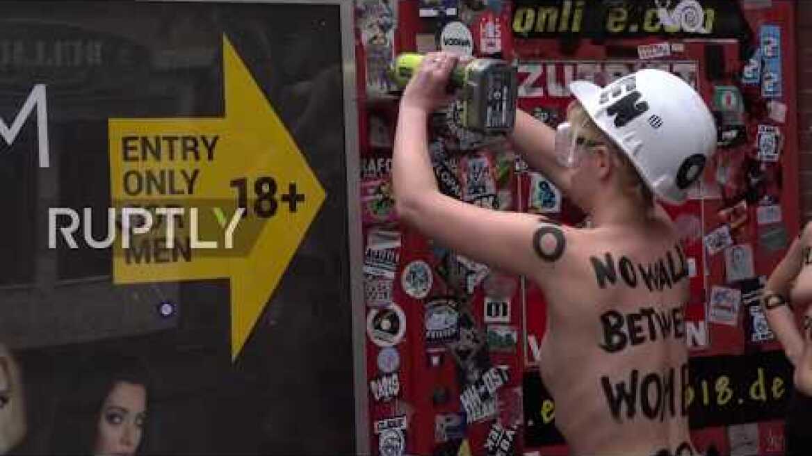 Germany: Topless Femen activists tear down Hamburg red light district wall *EXPLICIT*