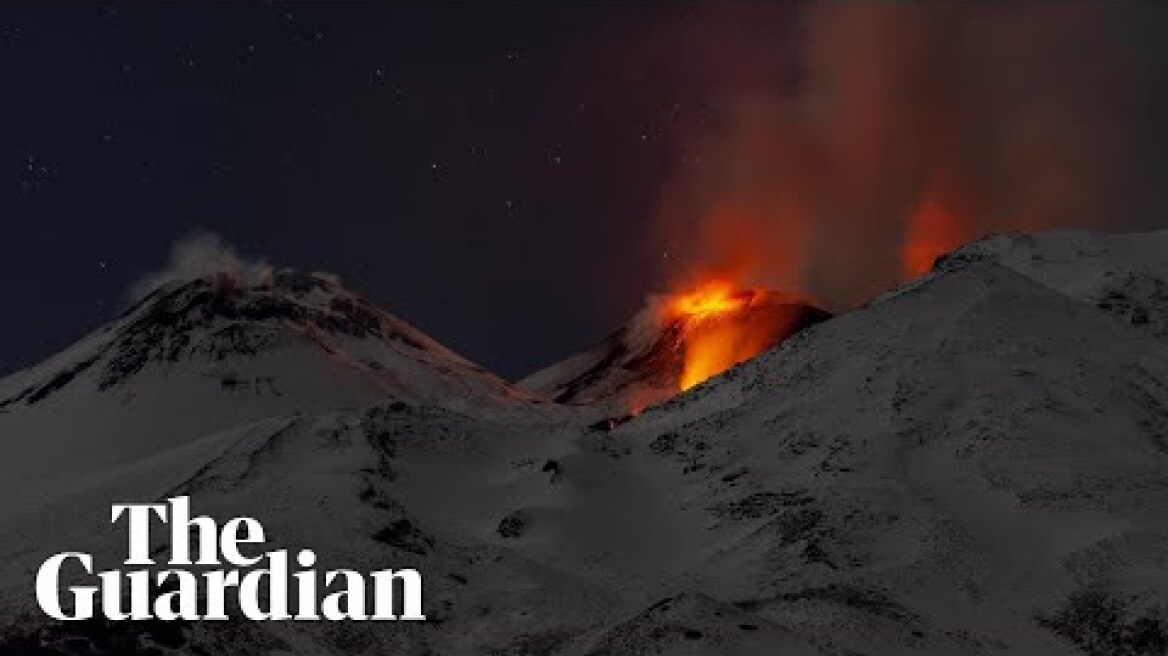 Snow-covered Mount Etna spews lava and ash as it erupts