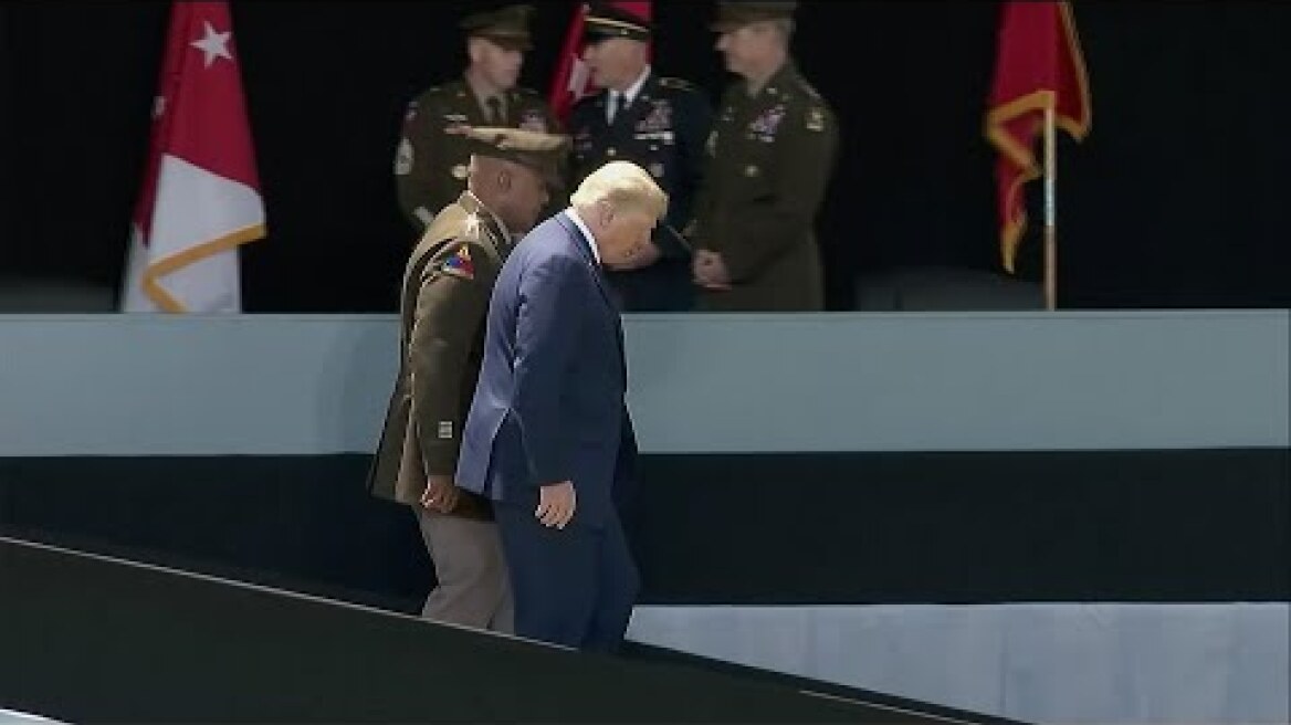 Trump appears to steady himself walking down West Point ramp