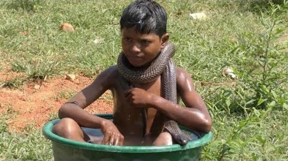 Seven-Year-Old Boy Bathes With Snakes