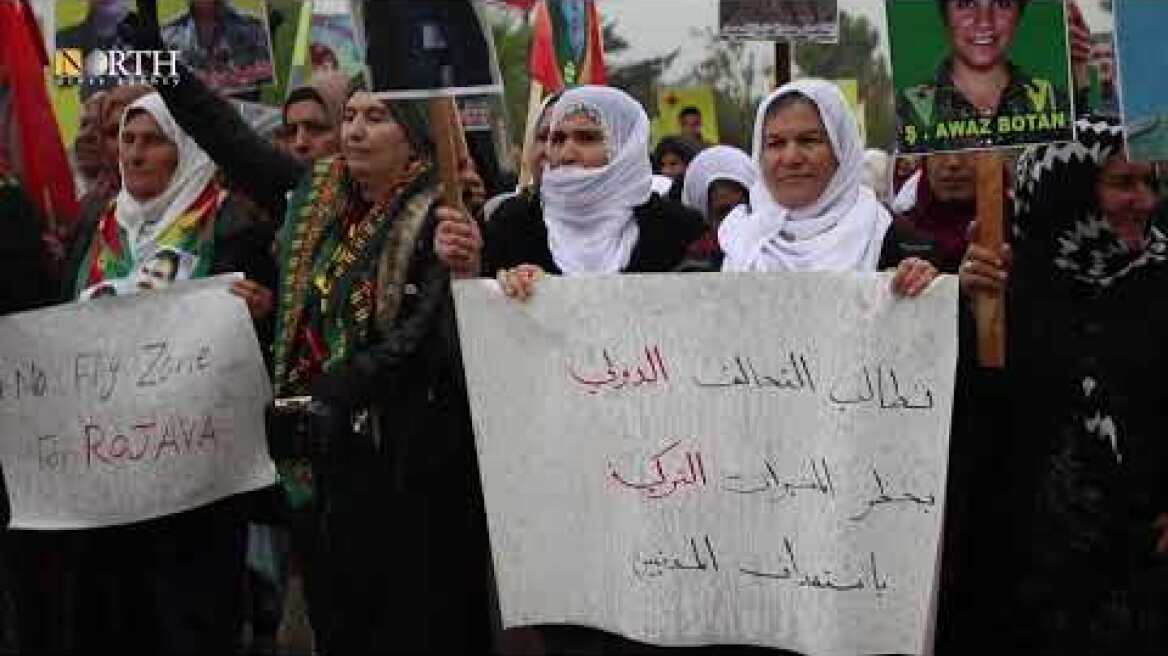 Residents protest Turkish attacks in front of a Russian base in Syria’s Qamishli