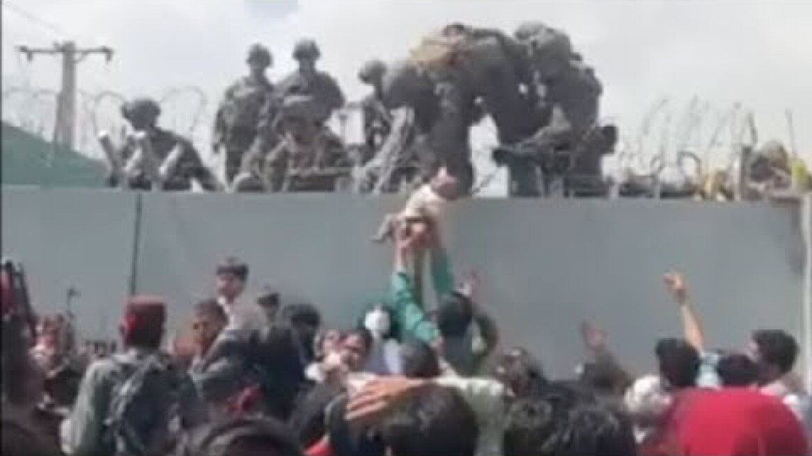 Desperate Afghan Mother Has Baby Handed Through Razor Wire