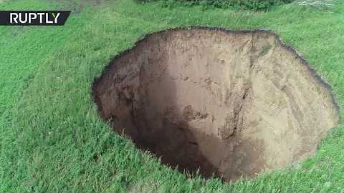 Massive sinkhole appears in the middle of a field in Russian countryside