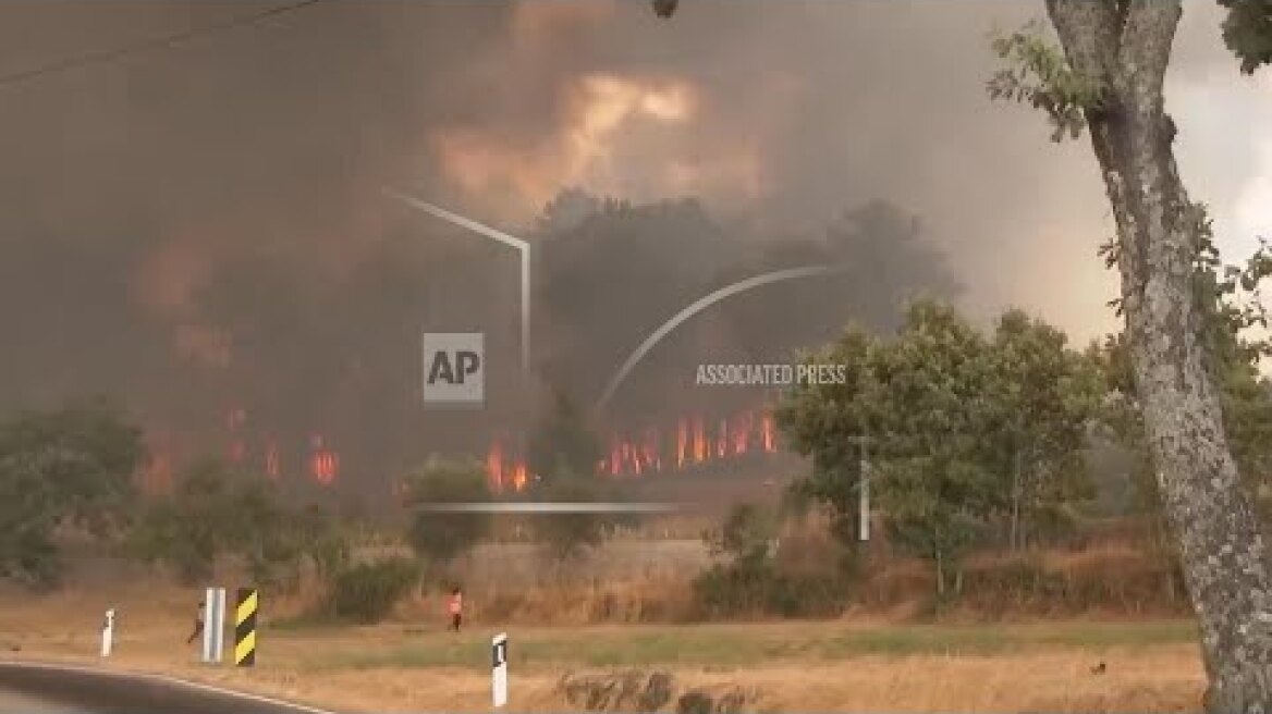 Firefighters and local residents battle wildfires in Portugal