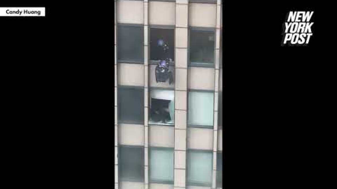 Video shows NYPD scale building to end 8-hour standoff with attempted jumper | New York Post