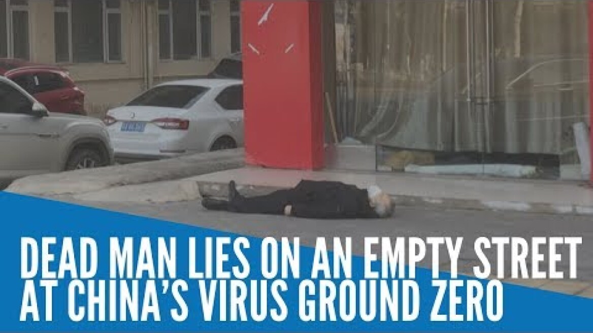 Dead man lies on an empty street at China's virus ground zero