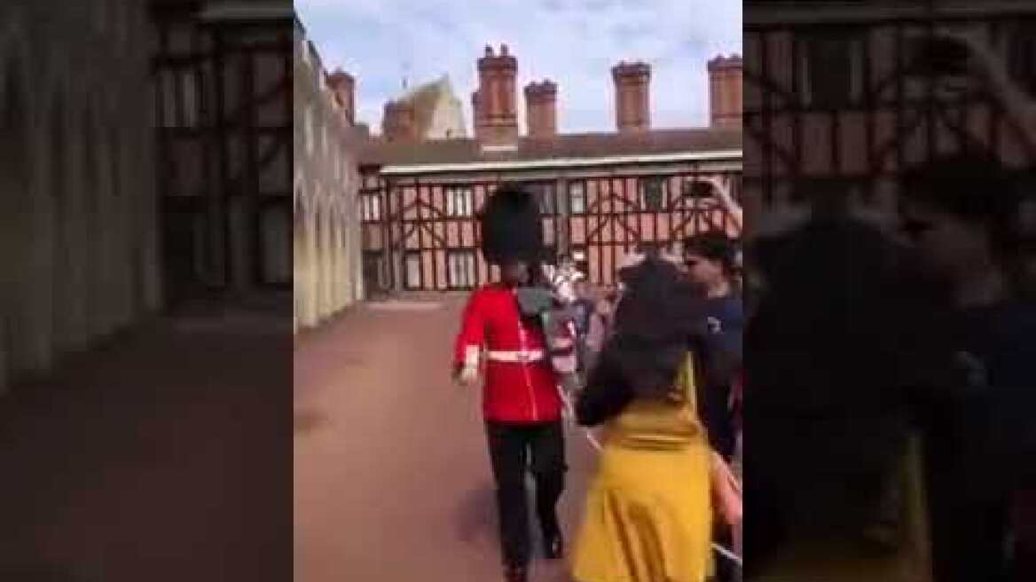 Woman pushed away by royal guard, She crossed the line to pose for photos