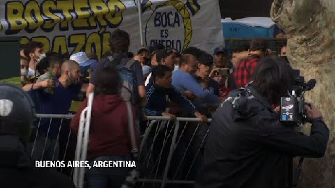 Maradona fans try to rush building to see coffin