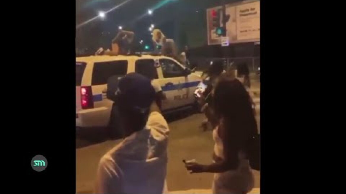 Black women twerking on a Chicago Police patrol car