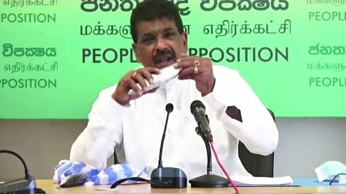 Sri Lankan lawmaker eats raw fish to promote sales