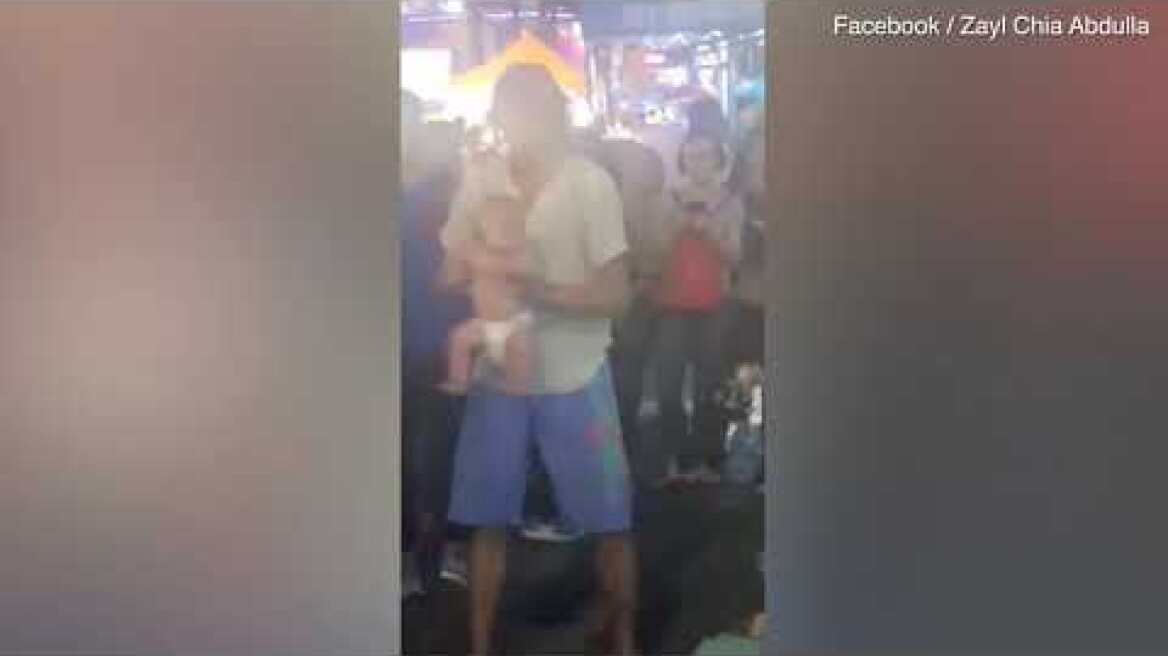 Russian dad swings his baby around during street performance