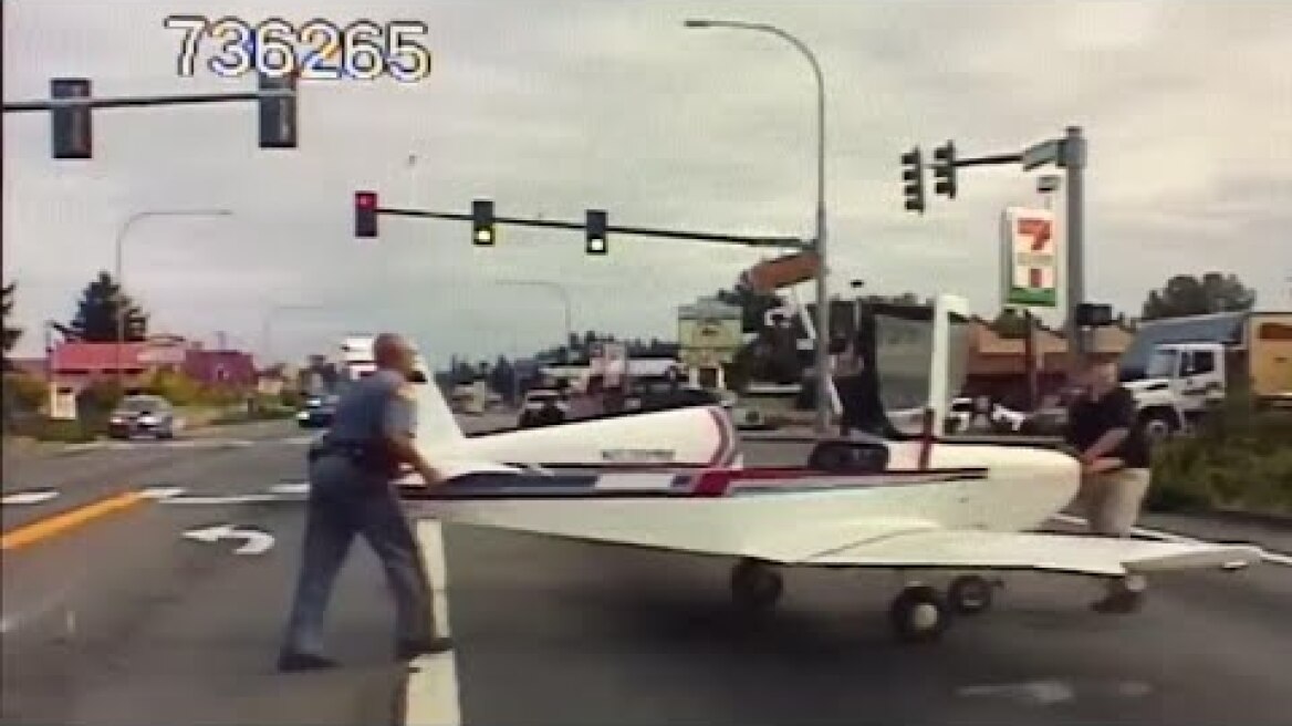 Small plane lands on road as police dashcam rolls