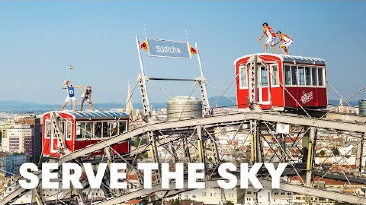 Two beach volleyball teams serve the sky from a ferris wheel.