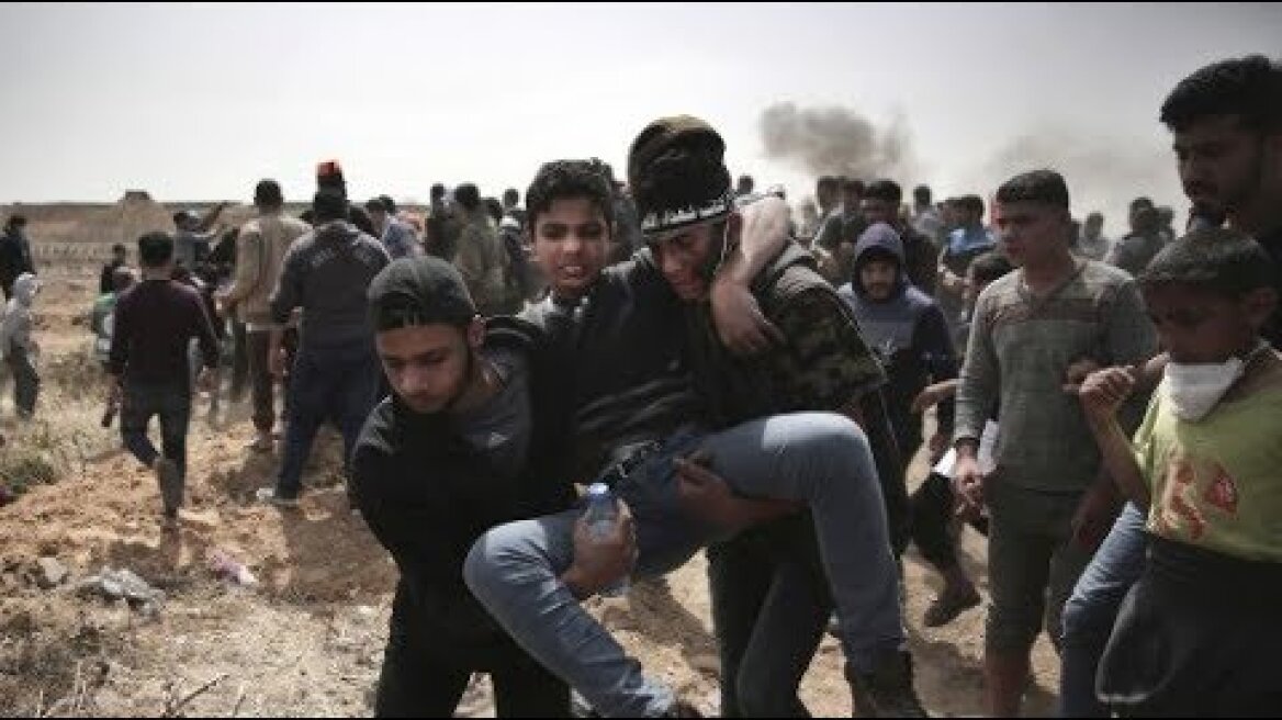 Palestinians burn Israeli flags in mass protest on Gaza-Israel border