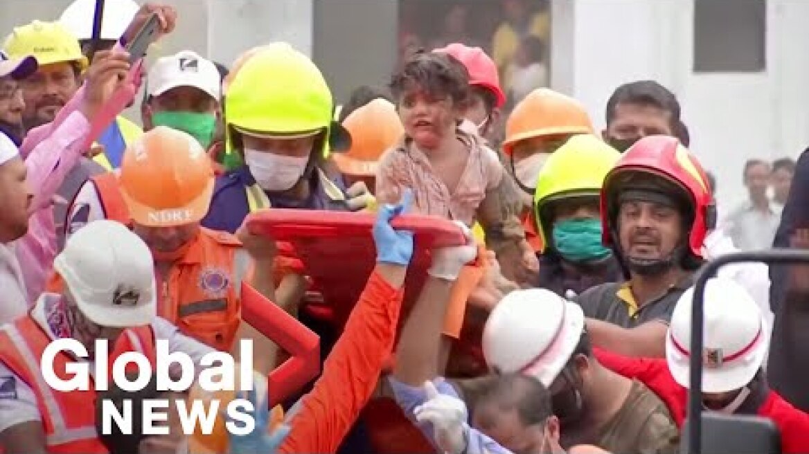 Child pulled from the rubble following deadly building collapse building in India