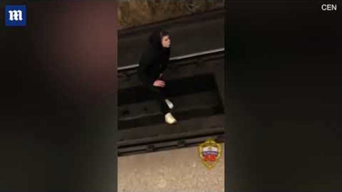 Heart-stopping moment student jumps onto train tracks for prank