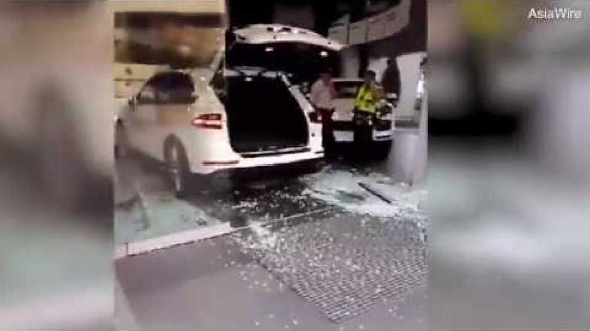 Moment furious businessman crashes Porsche into dealership