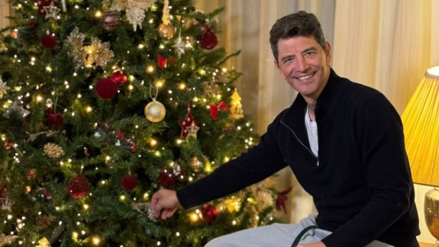 Ο Σάκης Ρουβάς ποζάρει δίπλα στο χριστουγεννιάτικο δέντρο στο σπίτι του